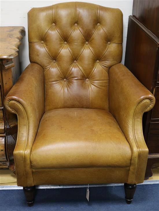 A pair of tan leather armchairs